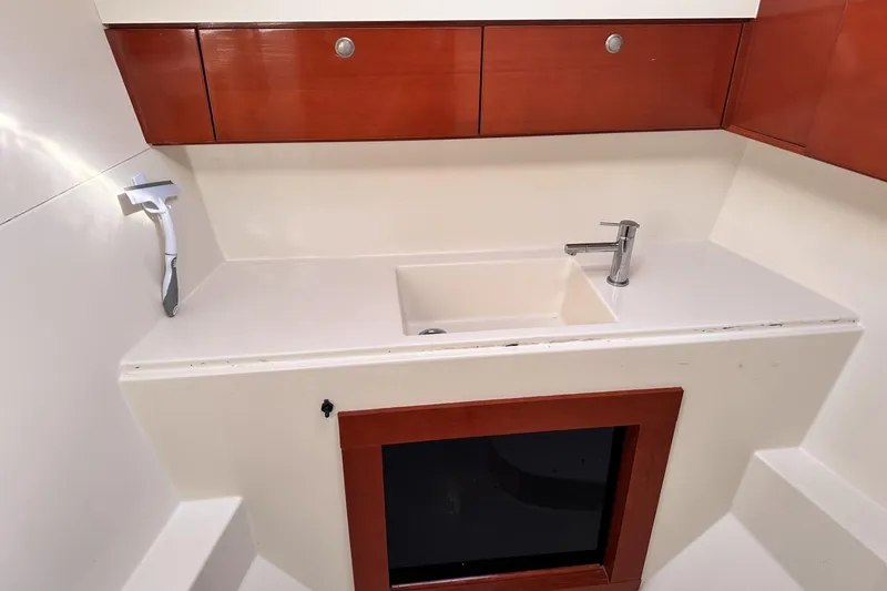 Slide: The Image of Interior of 2006 Hanse 461 yacht showing a modern sink and wooden cabinetry. - 24