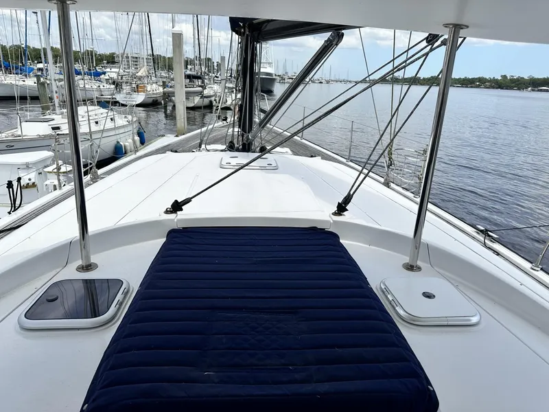 Slide: The Image of 2006 Hanse 461 sailboat deck with blue cushion, docked at marina. - 33