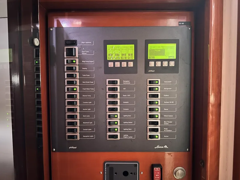 Slide: The Image of Electrical control panel on a 2006 Hanse 461 yacht, featuring switches and digital displays. - 35