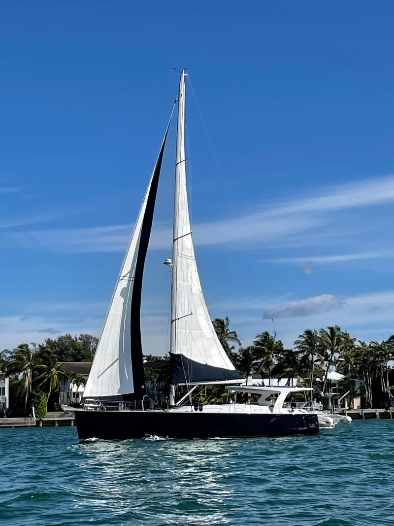 Slide: The Image of Sailing yacht Hanse 461, 2006 model, cruising on a sunny day with palm trees in the background. - 40