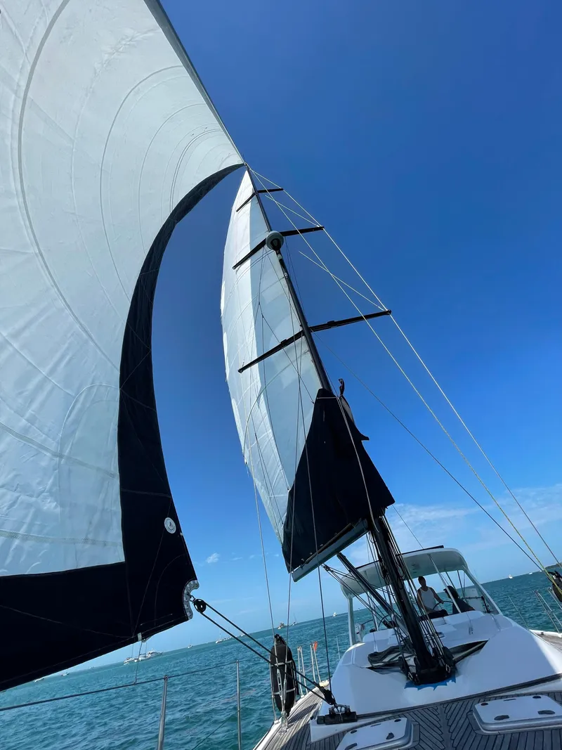 Slide: The Image of Sailing on a 2006 Hanse 461 yacht with full sails against a clear blue sky. - 41