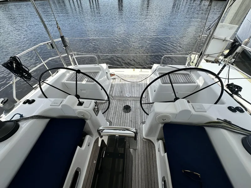 Slide: The Image of Dual helm stations on a 2006 Hanse 461 yacht, overlooking calm waters. - 8