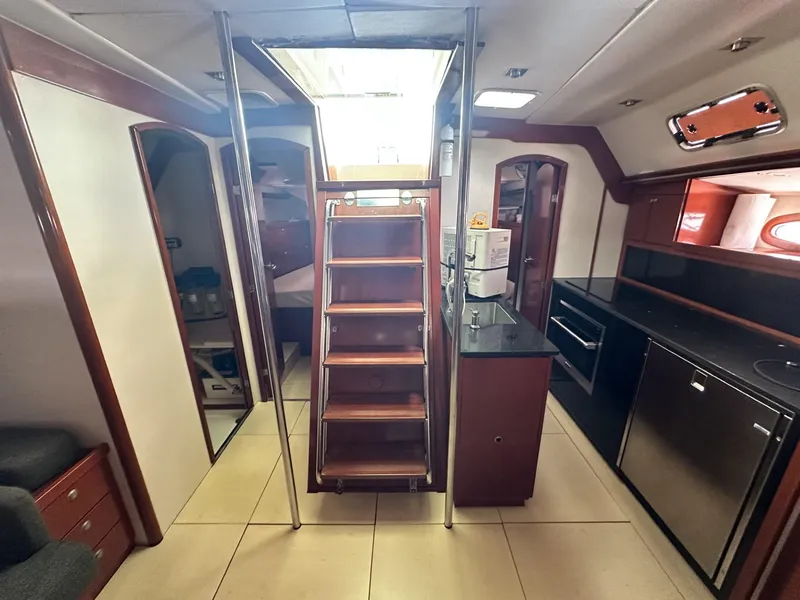 Slide: The Image of Interior of 2006 Hanse 461 yacht with modern kitchen and wooden staircase. - 9