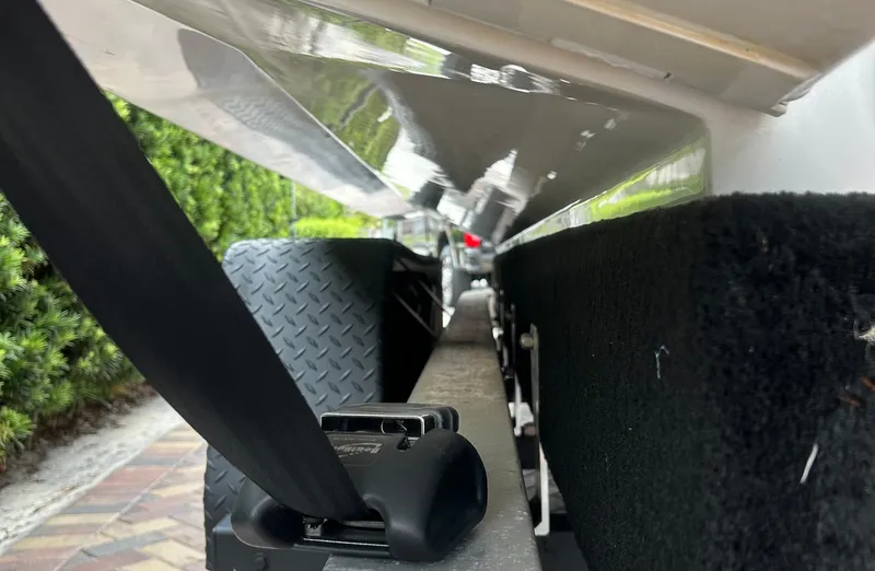 Slide: The Image of 2006 Hydra-Sports Vector 2900 CC boat trailer close-up, showing secure strap and wheel detail. - 31