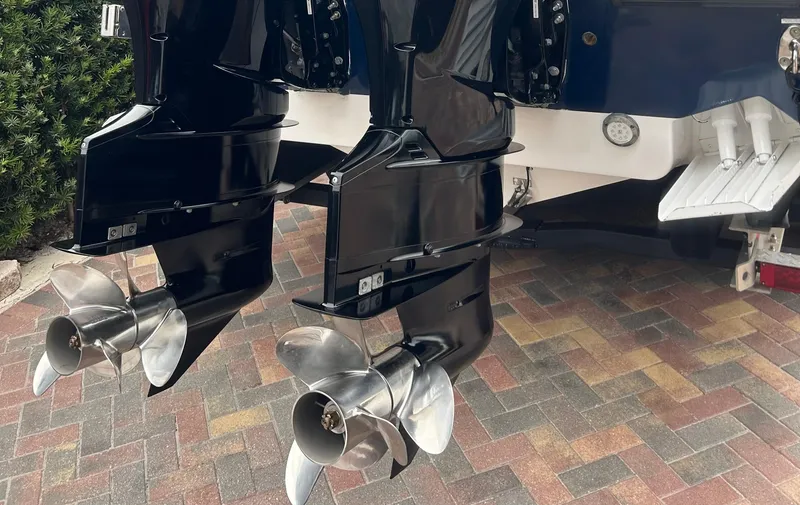Slide: The Image of Twin outboard motors on a 2006 Hydra-Sports Vector 2900 CC boat, parked on a brick driveway. - 6