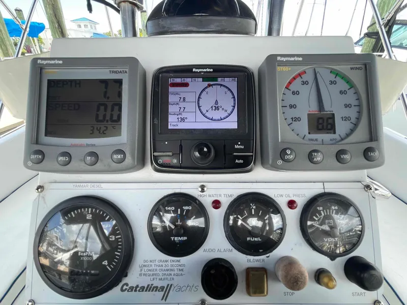 Slide: The Image of Control panel of a 2006 Hunter 309 sailboat with navigation and engine gauges. - 11