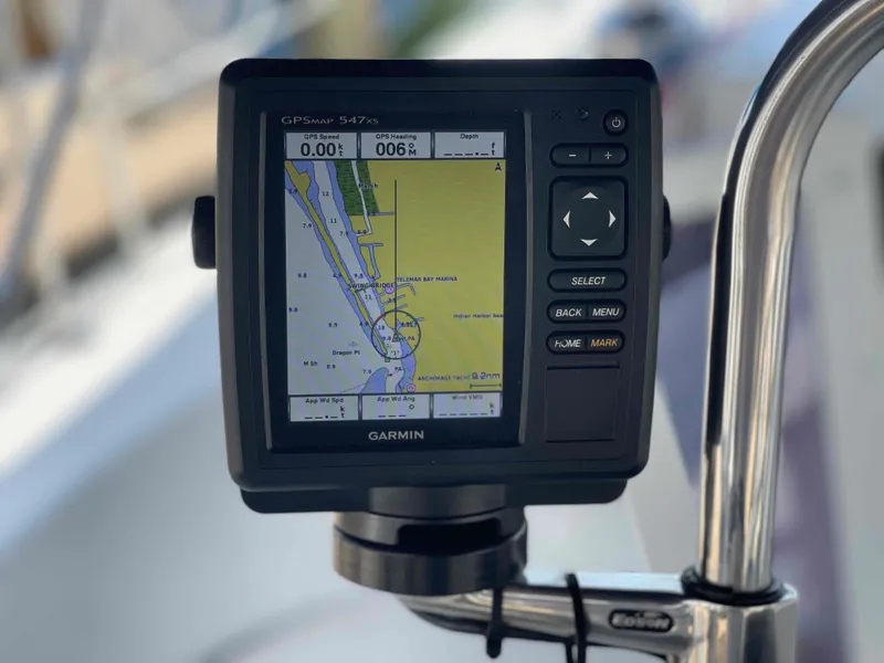 Slide: The Image of Garmin GPS device on a 2006 Hunter 309 sailboat, displaying navigation map. - 12
