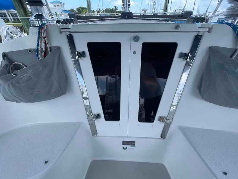 Slide: The Image of Cockpit view of a 2006 Hunter 309 sailboat with closed cabin doors. - 18