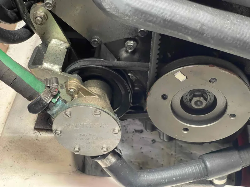 Slide: The Image of Close-up of a 2006 Hunter 309 engine component with visible belts and hoses. - 20