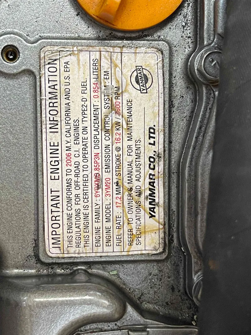 Slide: The Image of Engine information label on a 2006 Hunter 309, detailing specifications and compliance. - 22