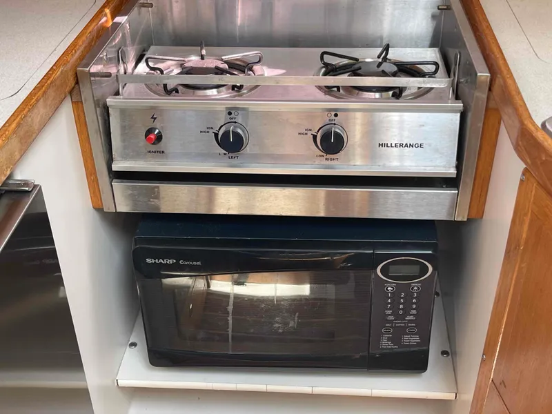 Slide: The Image of Stainless steel stove and microwave in a 2006 Hunter 309 kitchen setup. - 26