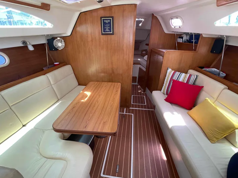 Slide: The Image of Interior of 2006 Hunter 309 sailboat with wood finish and cozy seating area. - 30