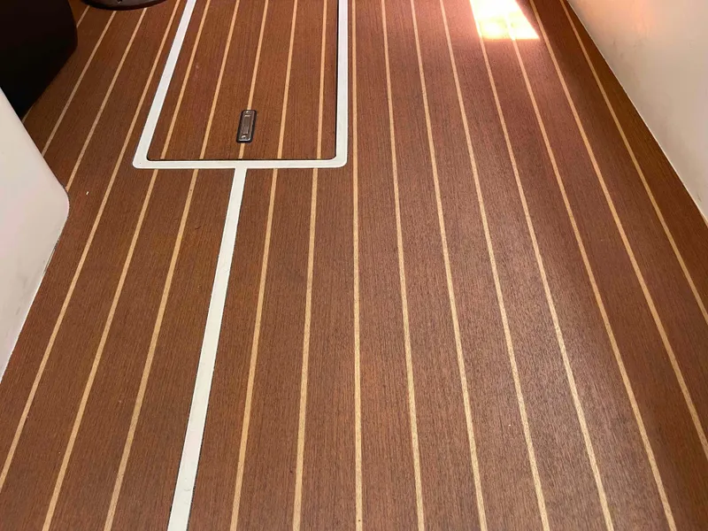 Slide: The Image of Teak-style flooring on a 2006 Hunter 309 boat interior. - 32