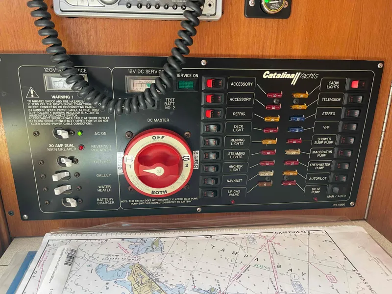 Slide: The Image of Electrical control panel on a 2006 Hunter 309 sailboat with navigation chart. - 36