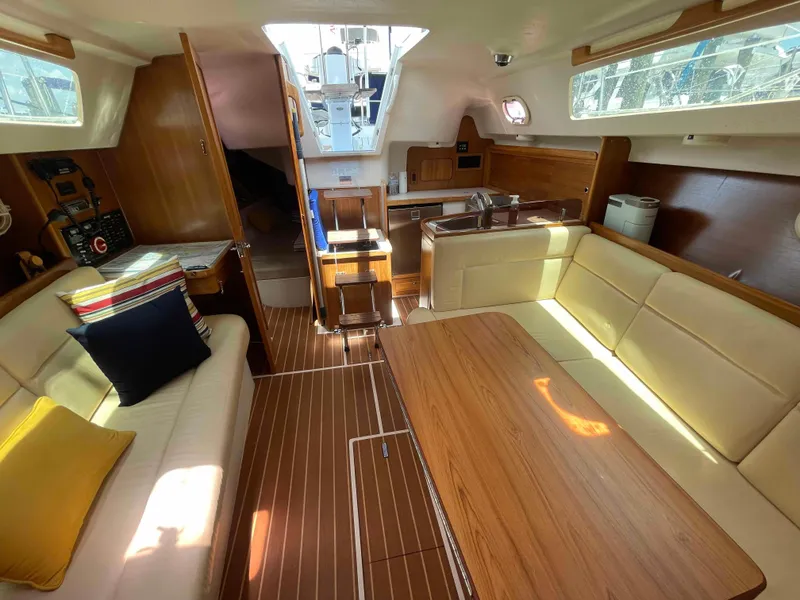Slide: The Image of Interior of a 2006 Hunter 309 sailboat with wood finishes and comfortable seating. - 37