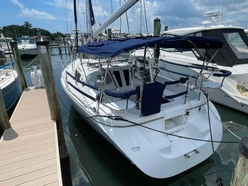 Slide: The Image of Sailboat docked at marina, 2006 Hunter 309 model with blue canopy. - 41