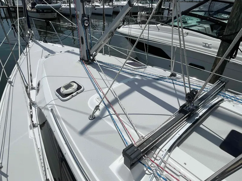 Slide: The Image of Sailboat deck of 2006 Hunter 309 with rigging and marina background. - 44