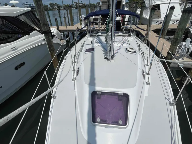Slide: The Image of 2006 Hunter 309 sailboat docked at marina, view of deck and rigging. - 46