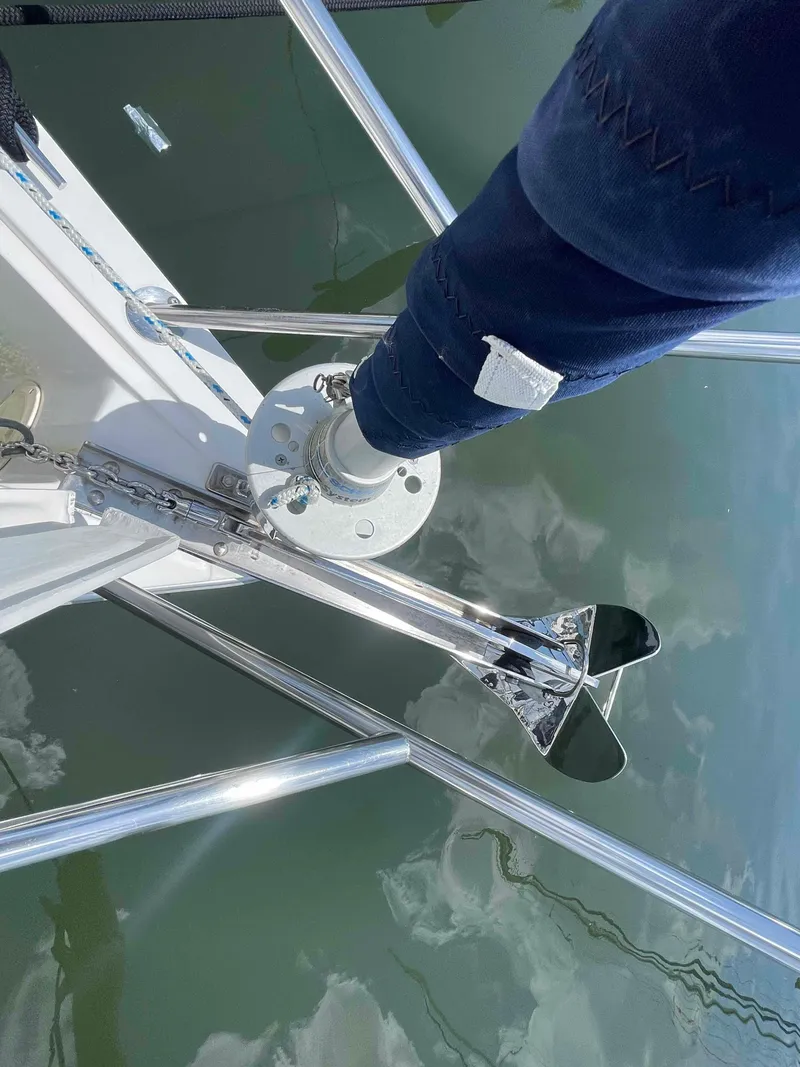 Slide: The Image of 2006 Hunter 309 sailboat mast and rigging detail over water. - 48