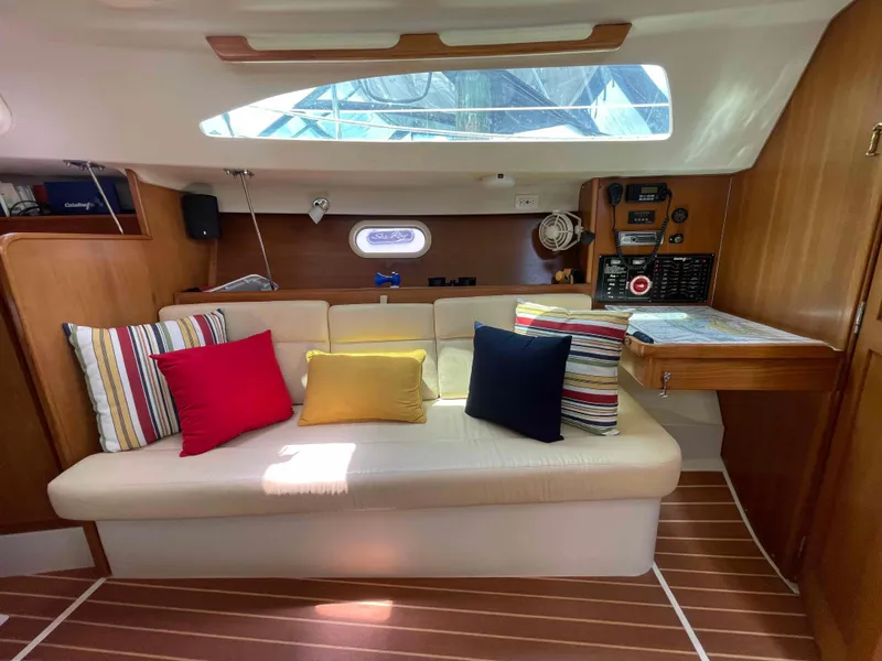 Slide: The Image of Interior of 2006 Hunter 309 sailboat with colorful cushions and wooden accents. - 5