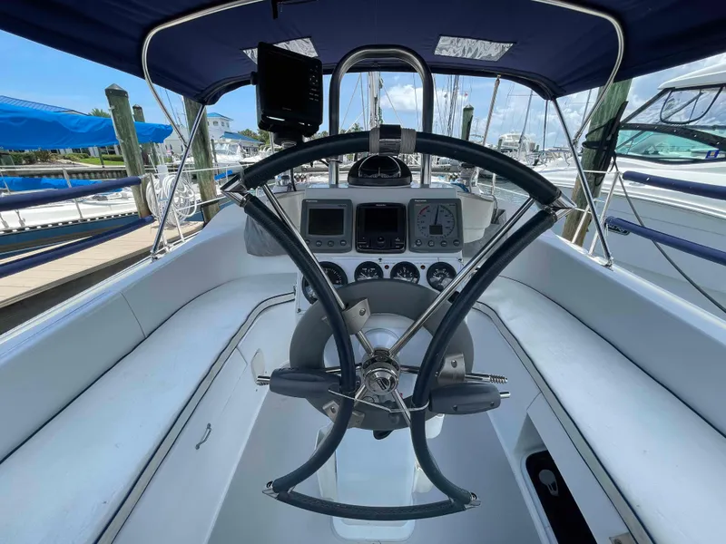Slide: The Image of Steering wheel and dashboard of a 2006 Hunter 309 sailboat at a marina. - 9