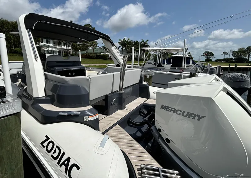 Slide: The Image of 2024 Zodiac Medline 9 boat with Mercury engine docked under a clear blue sky. - 10
