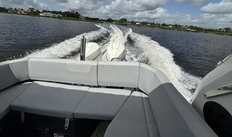 Slide: The Image of 2024 Zodiac Medline 9 cruising on a lake, showcasing rear seating and powerful wake. - 15