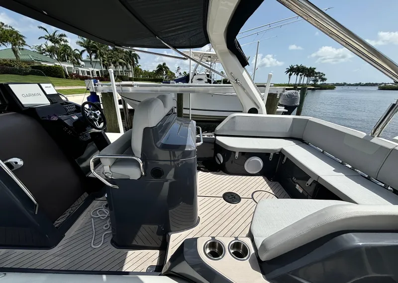 Slide: The Image of 2024 Zodiac Medline 9 boat interior with seating, steering console, and waterfront view. - 6