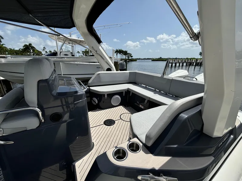 Slide: The Image of 2024 Zodiac Medline 9 boat interior with sleek seating and modern design, docked by the water. - 7