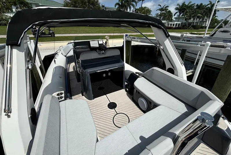 Slide: The Image of 2024 Zodiac Medline 9 boat interior with seating, docked at marina. - 9