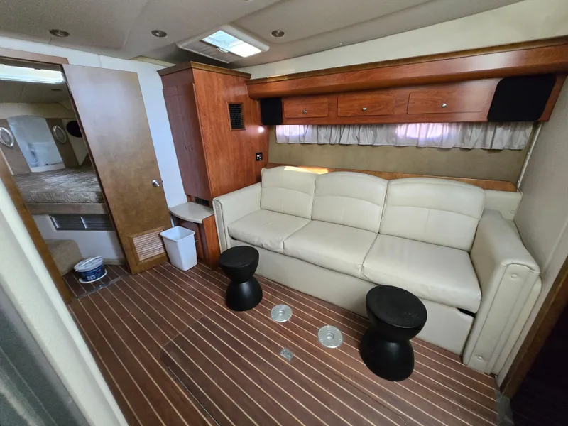 Slide: The Image of 2008 Rinker 400 Express Cruiser interior with sofa, wooden cabinets, and modern decor. - 11