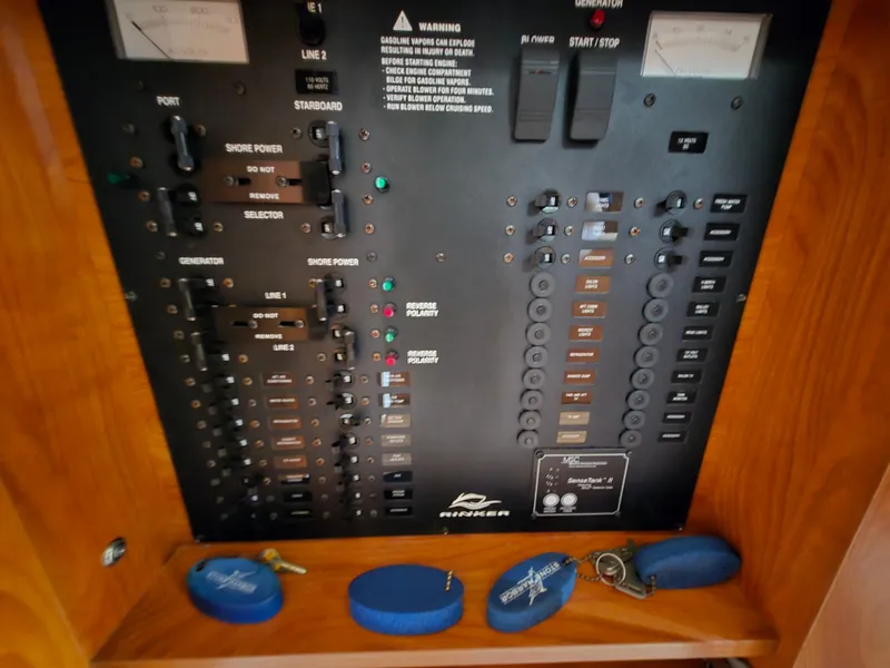 Slide: The Image of Electrical control panel of 2008 Rinker 400 Express Cruiser with switches and indicators. - 16
