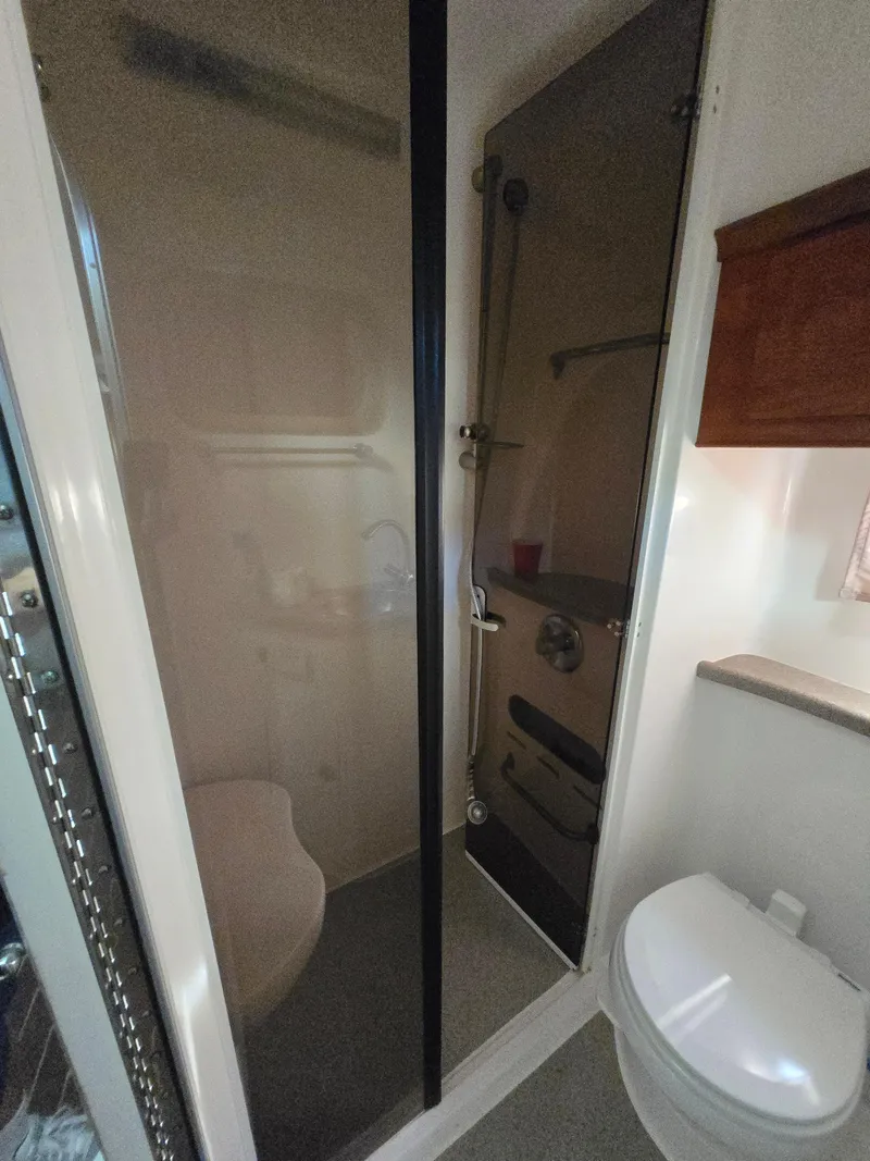 Slide: The Image of Bathroom interior of a 2008 Rinker 400 Express Cruiser with shower and toilet. - 22