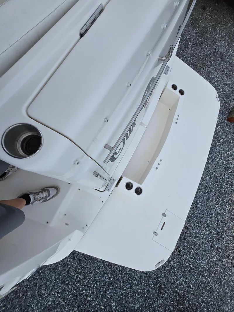 Slide: The Image of 2008 Rinker 400 Express Cruiser, white deck, rear view, docked on gravel surface. - 27