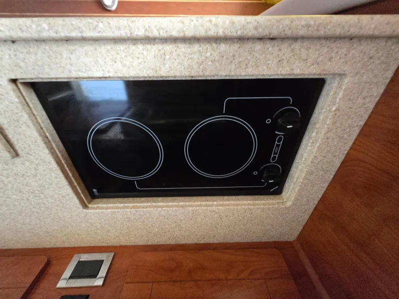 Slide: The Image of Built-in stovetop on 2008 Rinker 400 Express Cruiser yacht kitchen. - 28