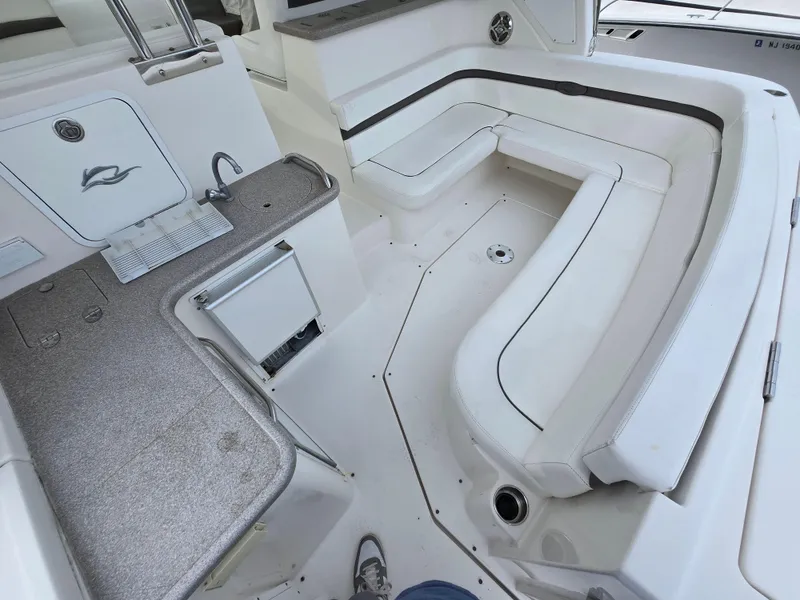 Slide: The Image of 2008 Rinker 400 Express Cruiser interior with white seating and kitchenette area. - 29