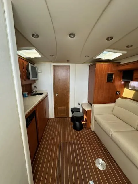 Slide: The Image of Interior of 2008 Rinker 400 Express Cruiser with wood flooring and modern amenities. - 3