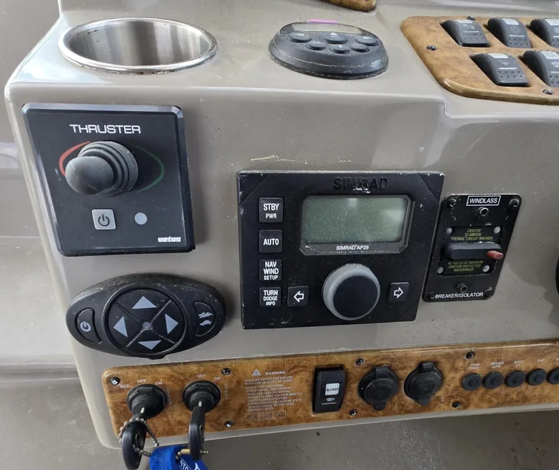 Slide: The Image of Control panel of a 2008 Rinker 400 Express Cruiser with navigation and thruster controls. - 30
