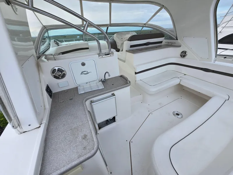Slide: The Image of 2008 Rinker 400 Express Cruiser interior with seating and kitchenette. - 32