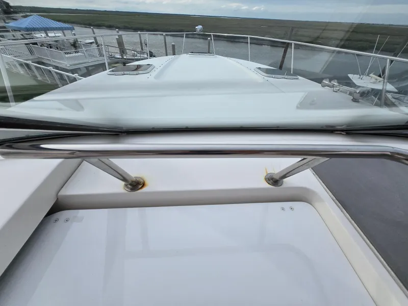 Slide: The Image of 2008 Rinker 400 Express Cruiser bow view at marina, showcasing sleek design and railing. - 39