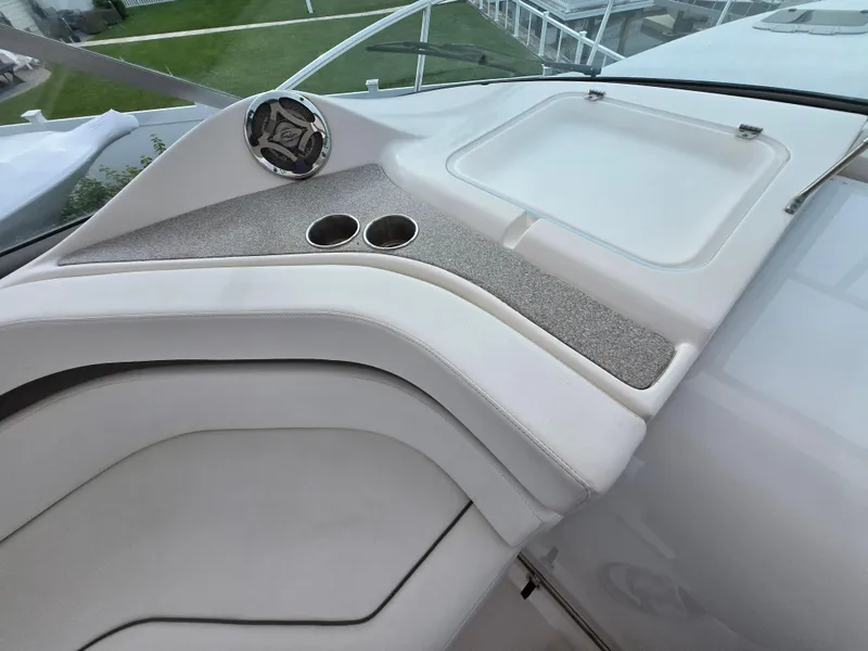 Slide: The Image of 2008 Rinker 400 Express Cruiser dashboard with cup holders and storage compartment. - 40