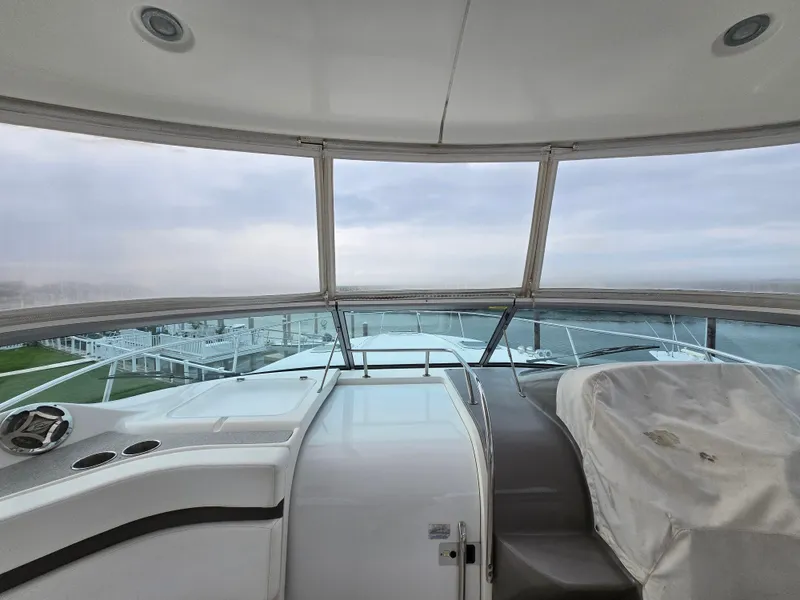 Slide: The Image of 2008 Rinker 400 Express Cruiser helm with panoramic marina view. - 41