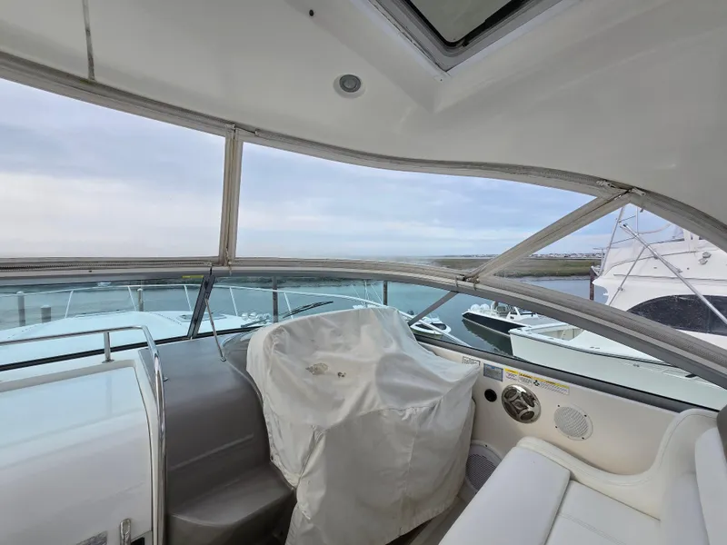 Slide: The Image of 2008 Rinker 400 Express Cruiser interior with covered helm and panoramic windows. - 42