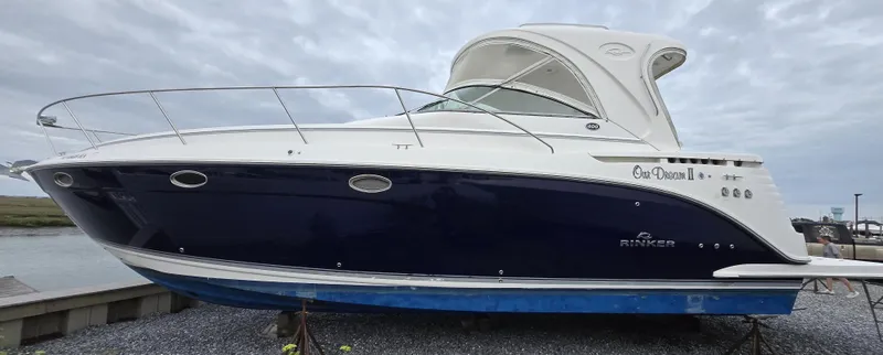 Slide: The Image of 2008 Rinker 400 Express Cruiser boat on gravel, side view. - 6