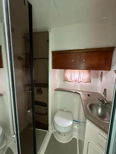 Slide: The Image of 2008 Rinker 400 Express Cruiser bathroom with sink, toilet, and shower. - 7