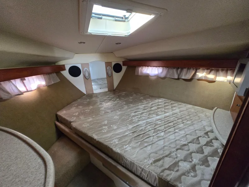 Slide: The Image of 2008 Rinker 400 Express Cruiser cabin with bed, skylight, and cozy interior. - 9