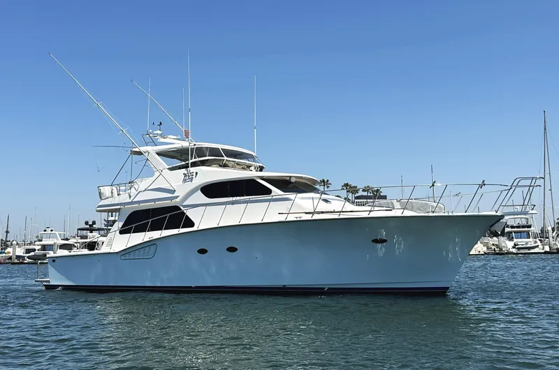 Slide: The Image of Mikelson 61 Sportfisher 2000 yacht on calm water, clear sky background. - 1