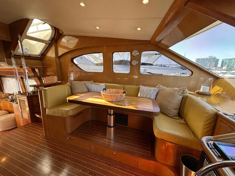 Slide: The Image of Luxurious interior of 2000 Mikelson 61 Sportfisher yacht with cozy seating and wooden accents. - 18