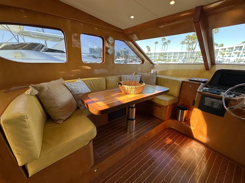 Slide: The Image of Luxurious interior of 2000 Mikelson 61 Sportfisher yacht with plush seating and wooden table. - 19