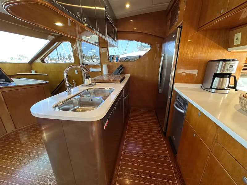Slide: The Image of Luxurious kitchen interior of 2000 Mikelson 61 Sportfisher yacht with modern appliances. - 21